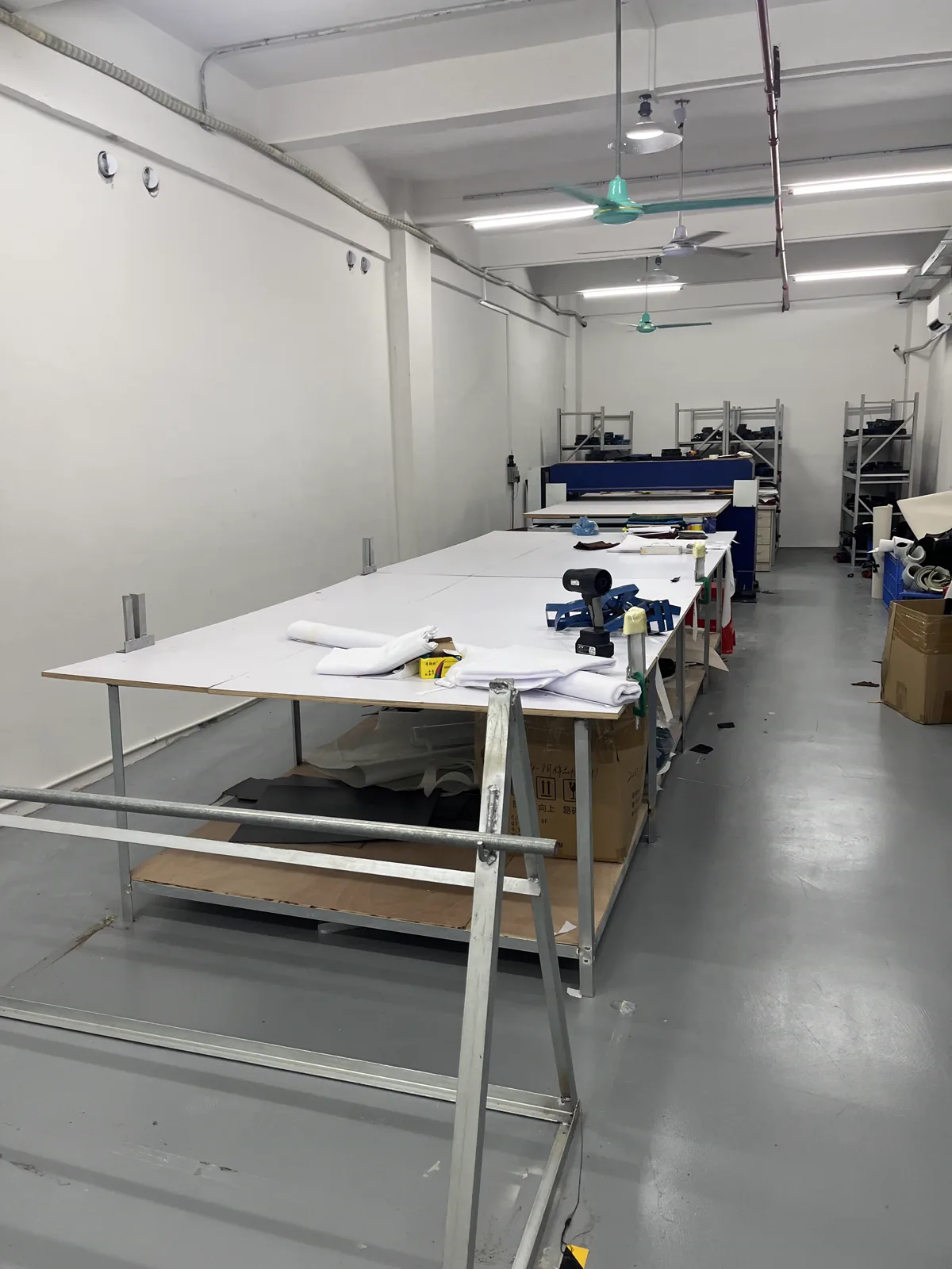 Fabric cutting tables and material preparation area inside the SXMX hat factory