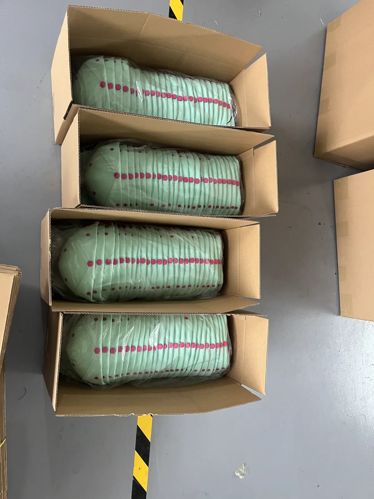 Finished custom hats packed for shipment at the SXMX factory
