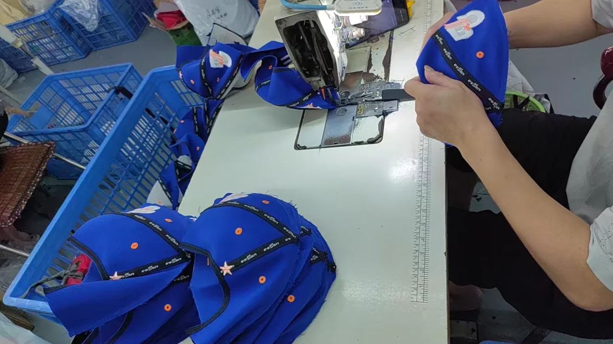 Hat panels being sewn during production at the SXMX factory